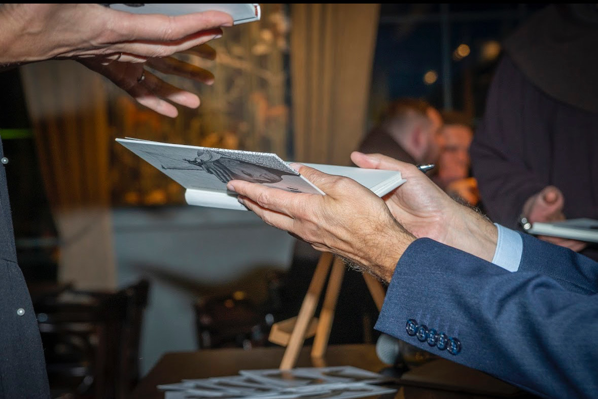 Hero image. A book which is being held by an author.